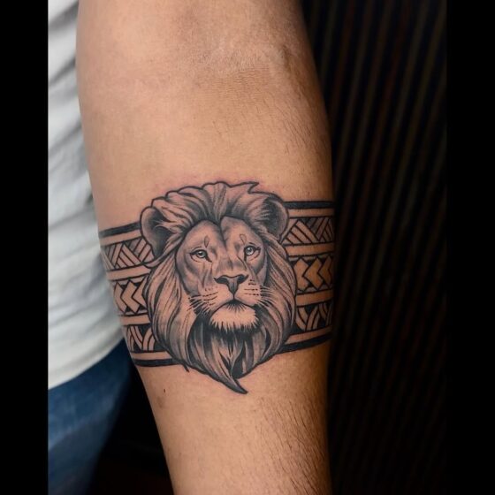 Lion Head with Tribal Patterns Tattoo